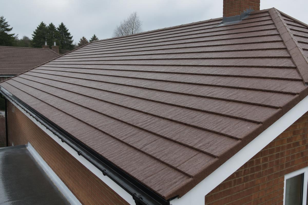 After roof cleaning: the same tiled roof with moss removed, guttering cleared and running freely, and fascias and soffits washed down.